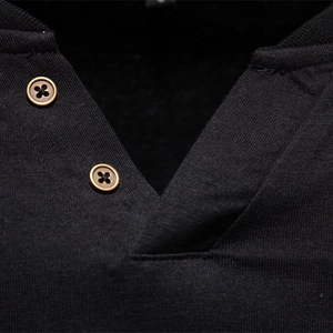 Close-up of black long-sleeve cotton V-neck T-shirt with vintage metal buttons