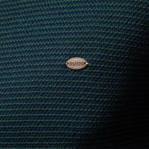 Men's quarter-zip knit sweater in dark green textured fabric with metal brand detail