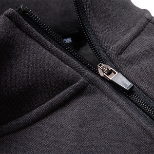Deep grey fleece-lined sweatshirt with premium metal zipper and textured fabric detail