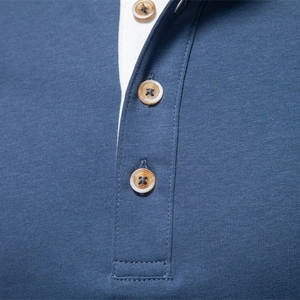 Men's dark blue Henley shirt with white contrast placket and amber-colored buttons