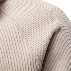Close-up of ribbed knit texture on a beige men's stand-collar zip hoodie shoulder seam