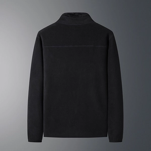 Detail view of the back of a black fleece jacket with a stand-up collar and warm texture