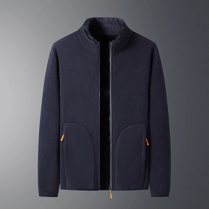 Detail view of navy blue fleece jacket with contrast orange zippers and warm inner collar