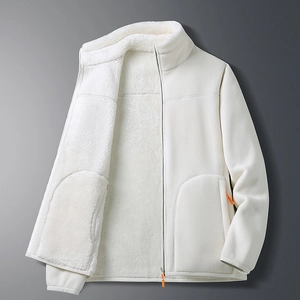 Detail of white double-sided fleece jacket showing high collar and orange zipper puller