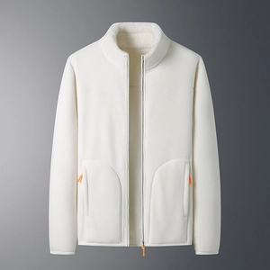 Close-up of cream fleece jacket featuring orange zipper detail and textured warm fabric