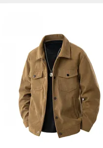 Detailed close-up of brown corduroy jacket fabric texture and metal button pocket