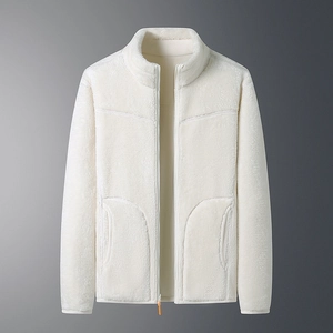Detailed macro view of the double-sided polar fleece jacket texture and zipper with orange tab