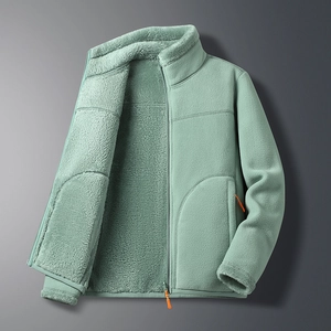 Detail of a thick polar fleece jacket with stand collar and bright orange zipper puller