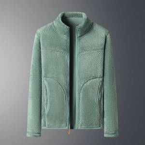 Detail of the warm green fleece jacket featuring stand collar and bright orange zipper pull