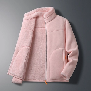 Close-up of pink fleece jacket with thick sherpa lining and orange zipper detail