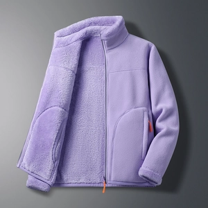 Detail view of purple fleece jacket with orange zippers and soft plush lining texture
