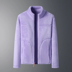 Detailed close-up of purple reversible fleece jacket with bright orange zipper pulls