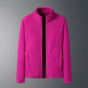 Detail view of pink fleece jacket with stand collar and orange zipper pulls