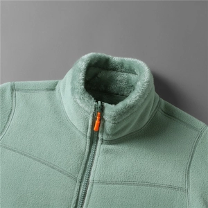 Detail of light green fleece jacket showing stand-up collar with soft plush lining