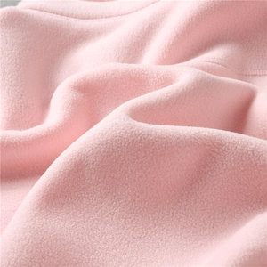 Macro detail of soft pink fleece fabric texture showing warmth and plush material