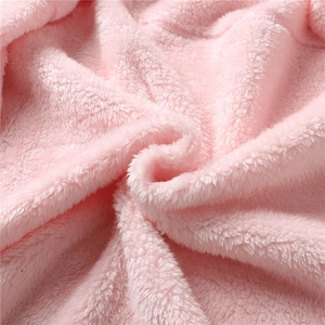 Macro close-up of pink high-density coral fleece fabric with soft plush texture