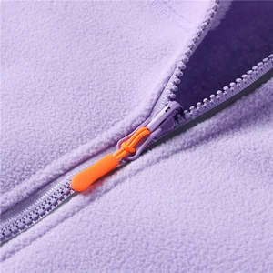 Detail of purple polar fleece jacket showing zipper with bright orange non-slip puller