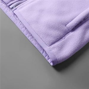 Detail of soft purple fleece jacket featuring a high-quality resin zipper and neat stitching