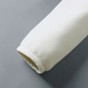 Close-up of ivory reversible fleece jacket showing detailed cuff texture and soft warm fabric