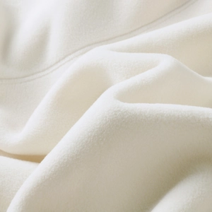 Macro shot of white fleece fabric showing soft texture and high-quality stitching details