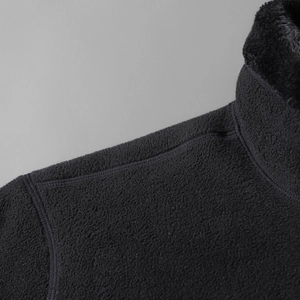 Detail view of black polar fleece jacket showing high-density texture and reinforced collar seam