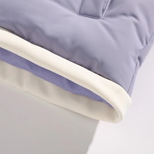 Detail of lavender and white quilted fabric with ribbed knit texture on a winter jacket