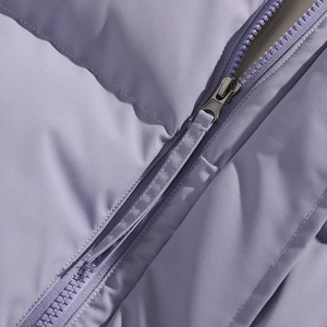 Detail of lavender puffer jacket featuring matte fabric and a smooth resin zipper
