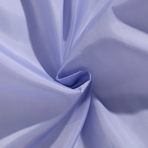 Macro shot of light purple fabric showing smooth texture and soft sheen of the padded coat