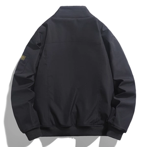 Dettaglio del retro del bomber nero con bordo a costine ed etichetta gialla sulla manica