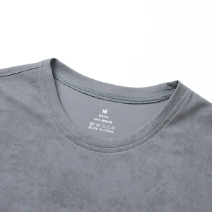 Primo piano del colletto della t-shirt grigia che mostra il tessuto 100% poliestere e mesh traspirante