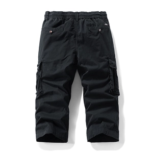 Detail view of men's black cargo pants showing the elastic waist and back button pockets