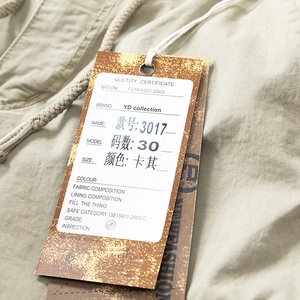 Detail of khaki cargo pants with drawstring waist and durable twill cotton fabric texture