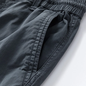 Detail showing elastic drawstring waistband and double stitching on dark gray cargo pants