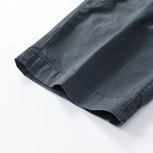 Close-up of charcoal gray cargo pants showing double-stitched seams and cotton texture