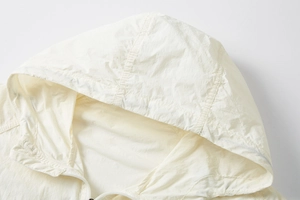 Detail of white ice silk UPF100+ sun protection jacket showing hood and fine stitching