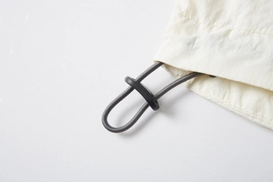 Macro shot of adjustable toggle and grey elastic drawstring on UPF100+ sun shirt