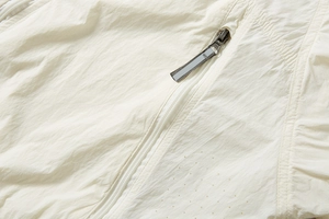 Detail of white ice silk sun protection jacket showing laser-cut breathability holes