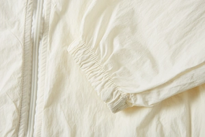 Detailed macro view of the UPF100+ sun protection jacket featuring elastic cuffs and zipper