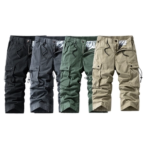 Flat lay of men's multi-pocket cargo capris in black, grey, green, and khaki colors