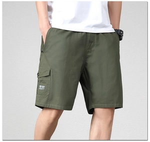 Detail of olive green cotton cargo shorts featuring a flap side pocket and brand woven label