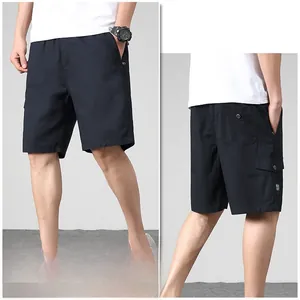 Detail of black cotton cargo shorts showing side flap pockets and durable texture