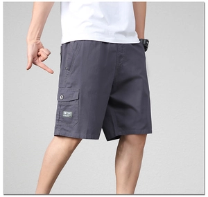 Detail view of cotton cargo shorts showing a side flap pocket and casual fashion patch