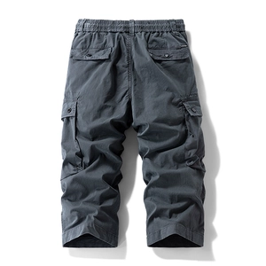 Detailed view of cargo shorts showing elastic drawstring waist and durable utility pockets