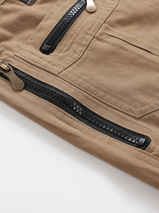 Detail of brown cotton cargo pants showing durable twill fabric and premium metal zipper
