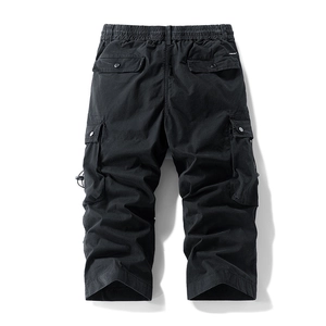 Detail of black utility cargo pants with elastic waistband and large functional side pockets