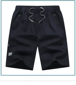 Detail of cotton cargo shorts showing elastic drawstring waist and side zip pocket