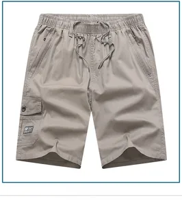 Detailed close-up of cotton cargo shorts featuring elastic waist and zip pockets