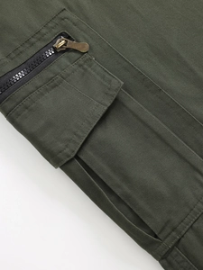 Detail view of cargo pants with army green twill fabric and bronze zipper pocket