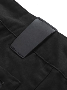 Close-up of black leather patch and stitching on the waistband of men's cotton cargo pants