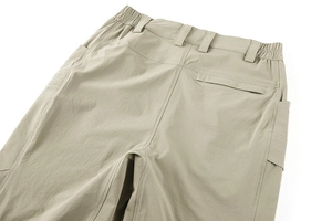 Detail of khaki tactical pants showing elastic waist, reinforced belt loops and pockets
